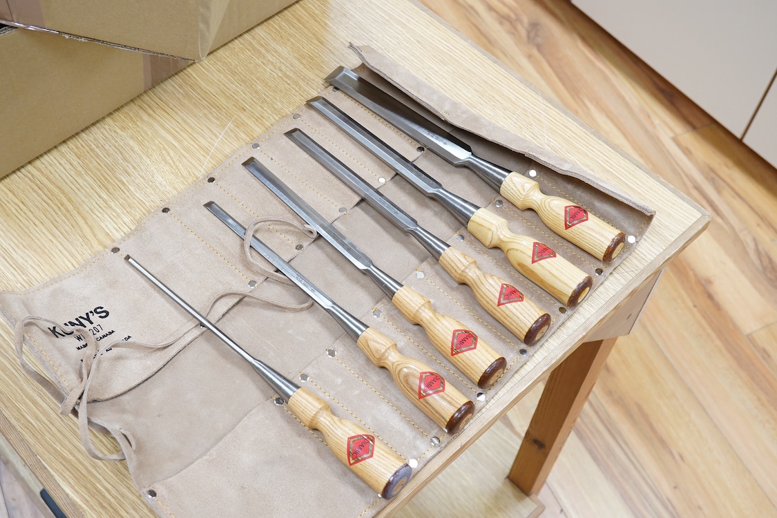 Five woodworking chisel sets, all in leather rolls, including an unused nine piece set by Robert Sorby, a six piece set by Henry Taylor, and three other sets showing some wear